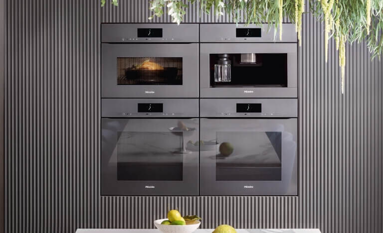 Cube of stunning Miele ovens in a modern kitchen