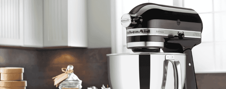 A black stand-mixer in a white kitchen.