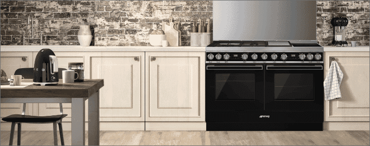 A double freestanding oven in a cream coloured kitchen.