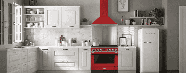 A striking red Smeg Portofino freestanding cooker and range hood in a white kitchen.