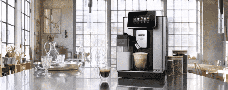 A sleek black and silver coffee machine in a industrial apartment.