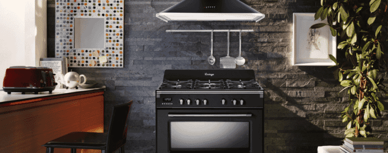 A black freestanding oven in a industrial kitchen.