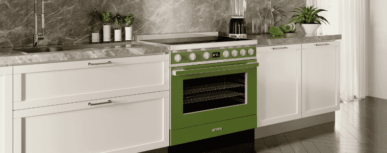 A green Smeg Portofino freestanding cooker in a white and grey modern kitchen.
