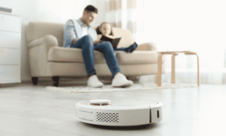 Robot Vacuum cleaning while family sit on their couch