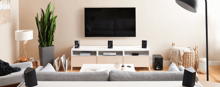 A living room with an extensive Logitech surround sound system.