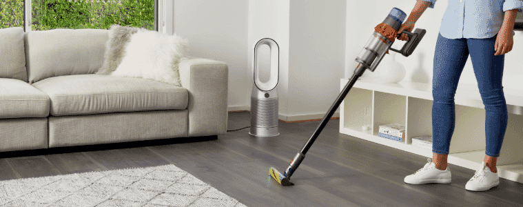 Person vacuuming their living space with the Dyson V15 Detect Absolute Cordless Vacuum