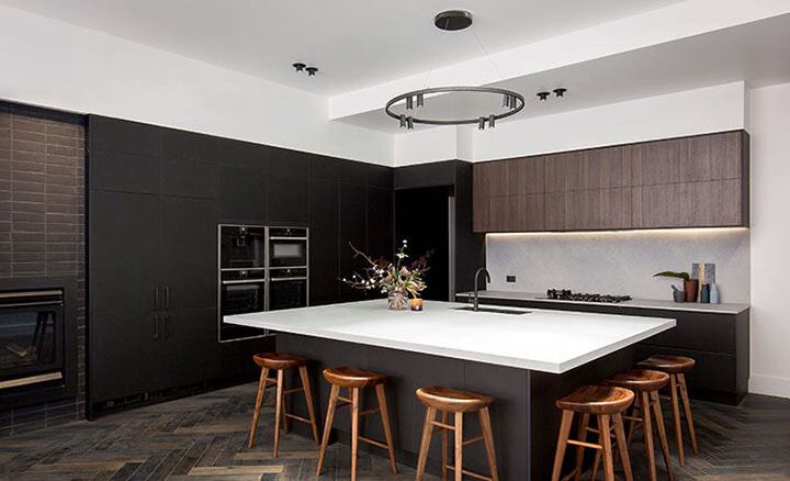 A sophisticated clean kitchen with a large island created by Kinsman Kitchens