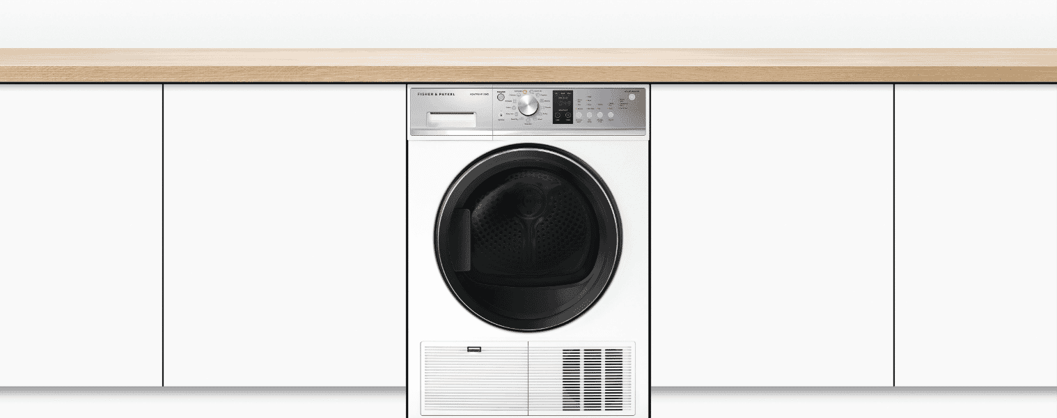 A washing machine in a white laundry.