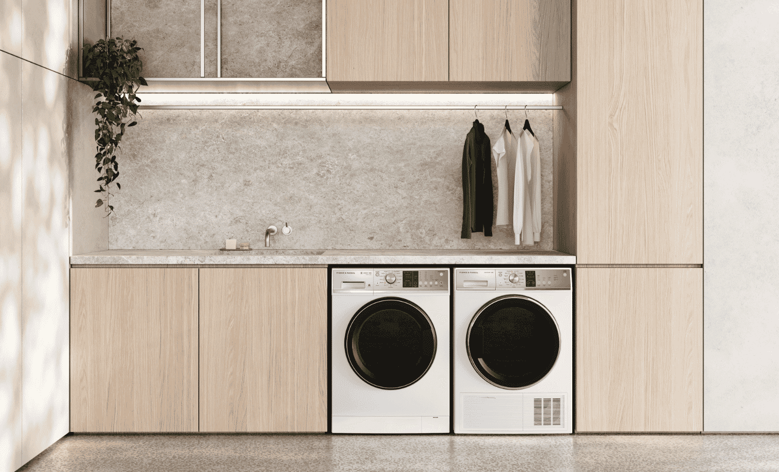 A matching washer and dryer in a light wood laundry.