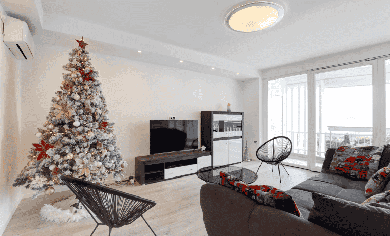 An apartment living room decorated for Christmas.