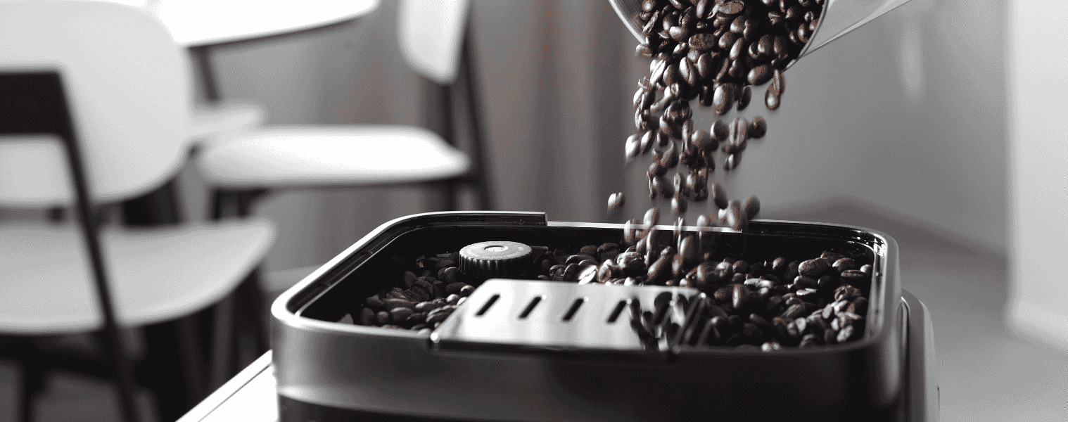 Coffee beans being poured into the Delonghi Magnifica EVO Titan Coffee Machine