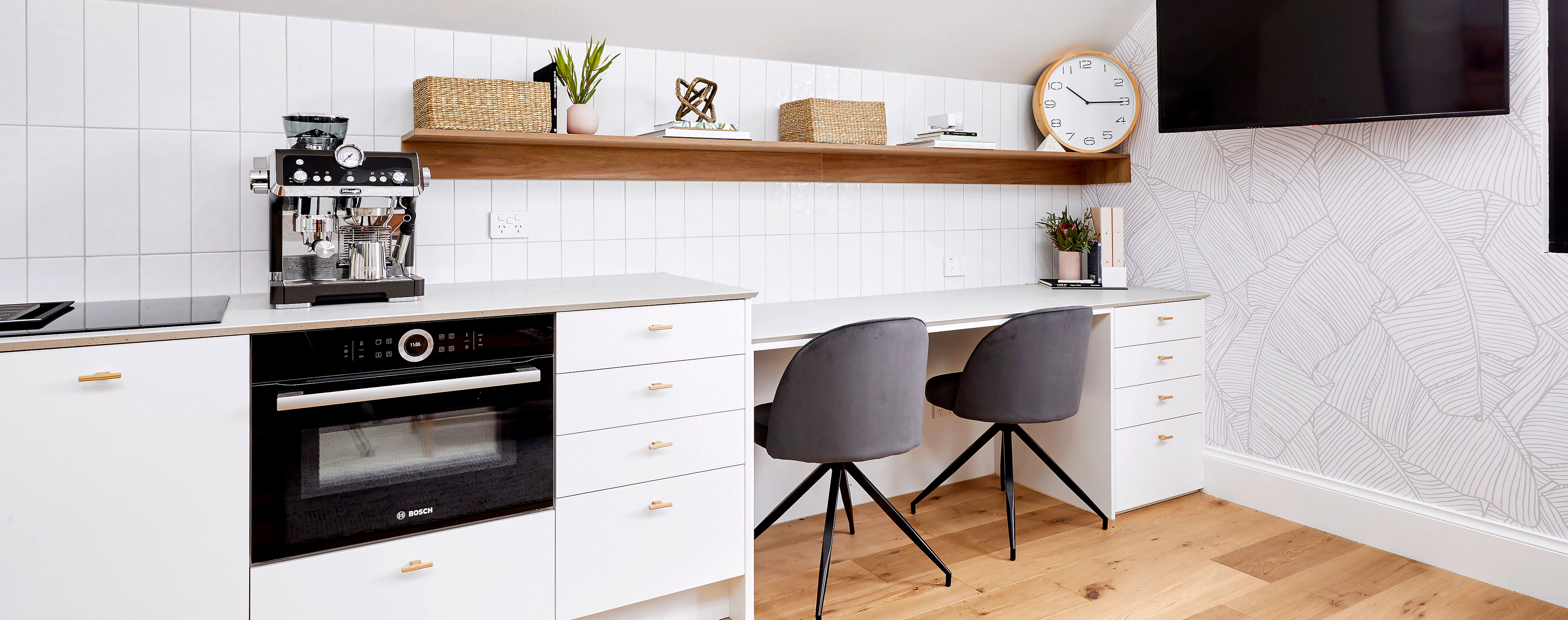 A Scandi-inspired home office adjacent to a modern kitchen