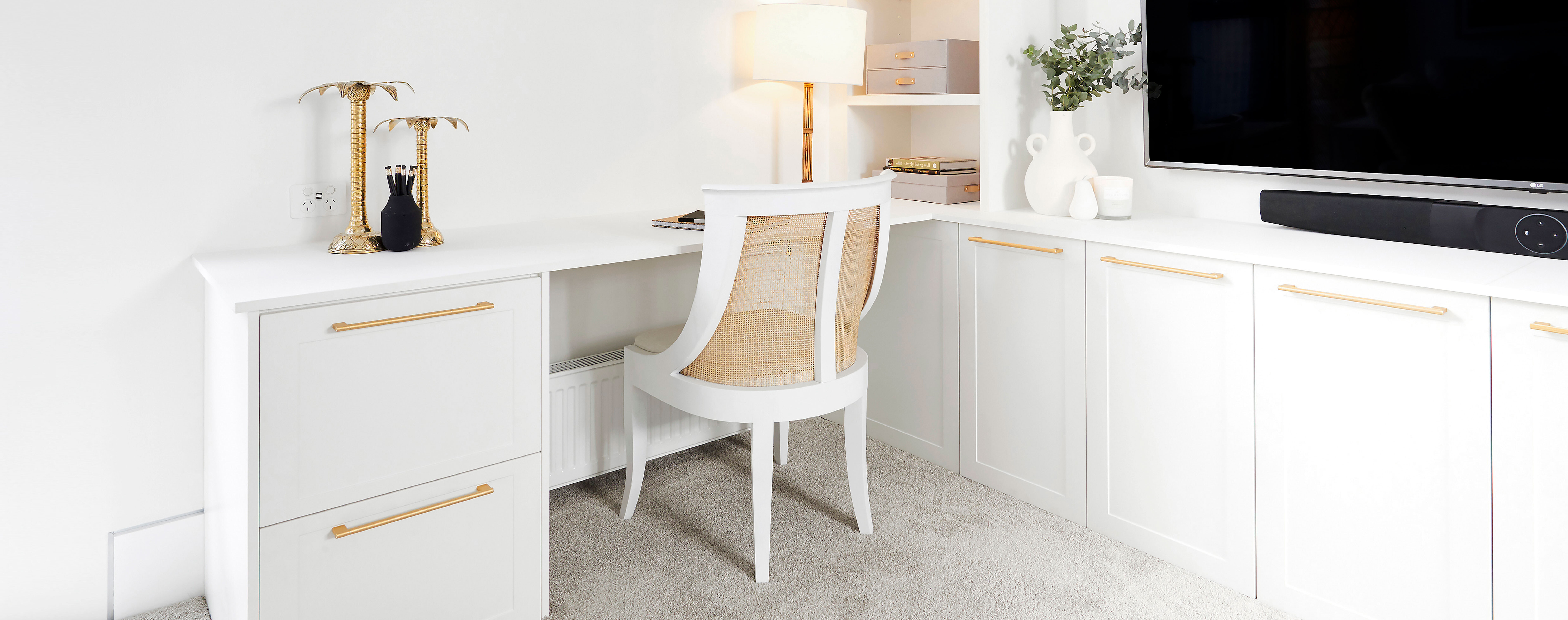 A white Hamptons-styled home office with gold accents