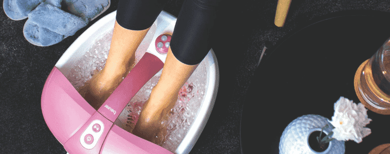 A person uses the Beurer Foot Spa.