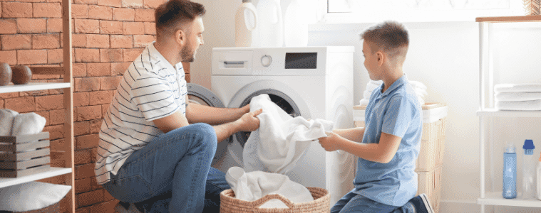 Father and son enjoying doing their laundry together.