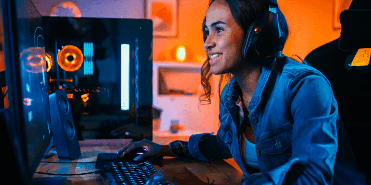 Smiling girl enjoying playing video games in her gaming room