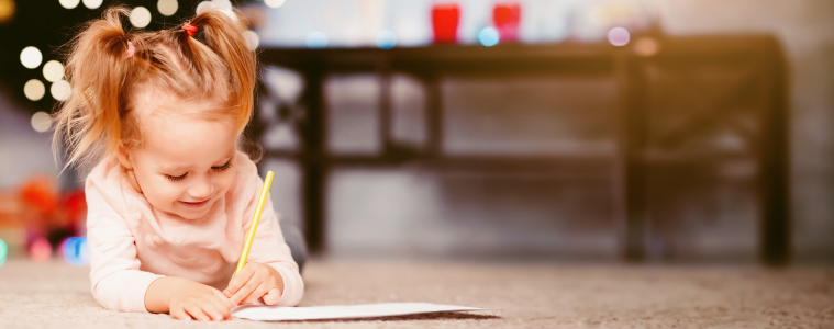 Cute girl writing her Christmas list for Santa