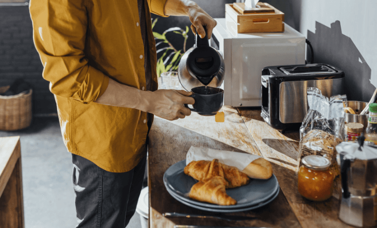 Man pouring a coffee at home for breakfast. 