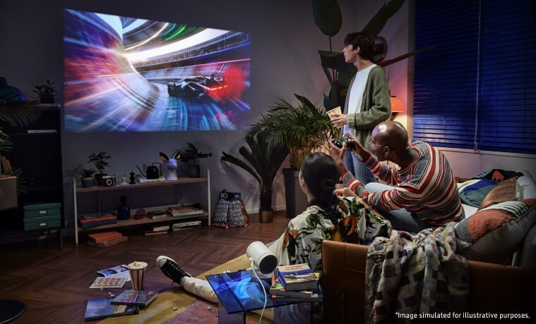 A group of friends watch a movie on Samsung's The Freestyle Portable Smart FHD Projector in a living room.
