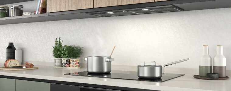 A sleek induction cooktop in a galley kitchen.