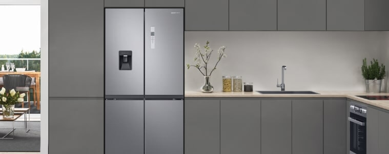 A slimline fridge in a grey kitchen.