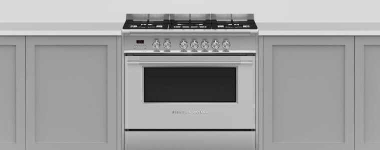 A chrome freestanding oven in a white kitchen.