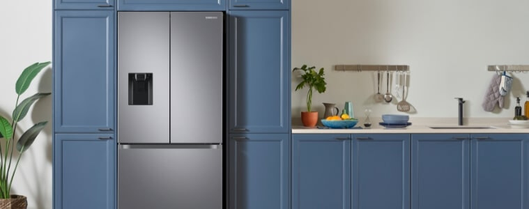 A chrome fridge in a blue straight line kitchen.