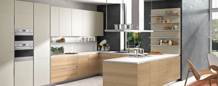 A cream and light timber coloured U-shaped kitchen.