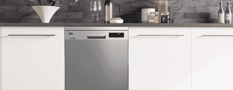 Beko stainless steel dishwasher in between white cabinetry.