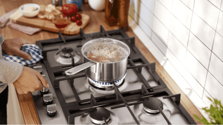 Gas cooktop with a pot of boiling water.