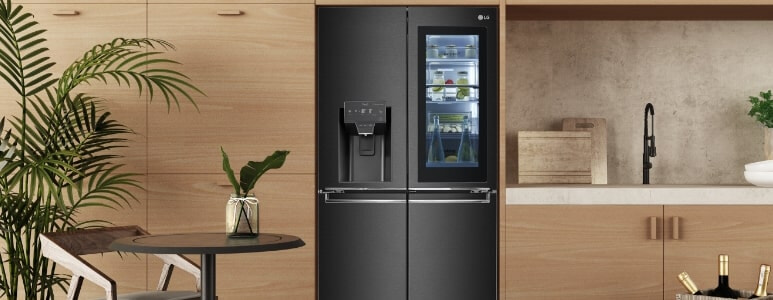 LG InstaView fridge in a kitchen with timber cabinetry.