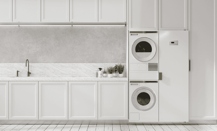 A stacked washer and dryer in a large white laundry.