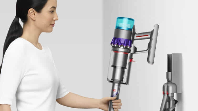 Woman docking her gen5detect absolute vac into the wall. 