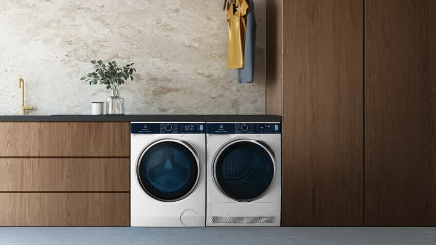 Electrolux matching washer and dryer in a modern laundry with wooden cabinetry