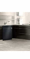 An LG QuadWash Dishwasher in a black and white modern kitchen.