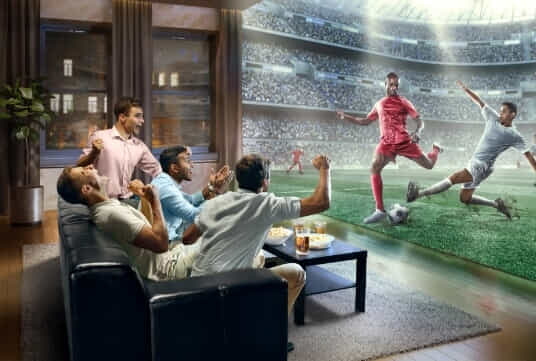 Men being apart of the action at home with their smart TV. 