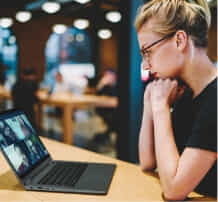 A lady looking at her laoptop.