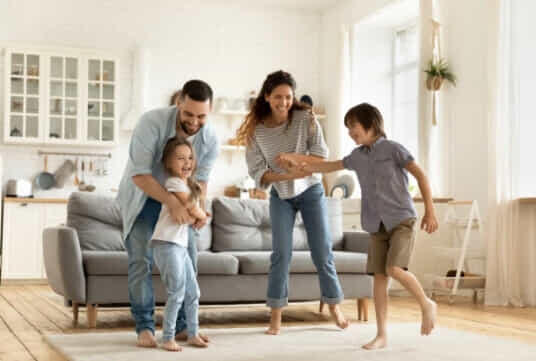 A young family spend time together in their living room.