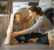 Mother and daughter playing under a blanket in the laundry in front of the washer and dryer | The Good Guys