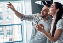 Male and female on their phone looking at something above them.|The Good Guys