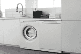 Dryer situated under a bench in a white laundry.|The Good Guys