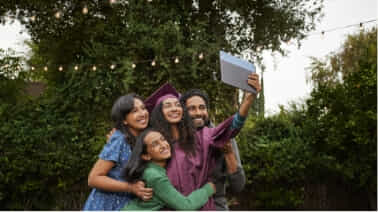 Family taking a group selfie with their Chromebook at their daughters graduation. 
