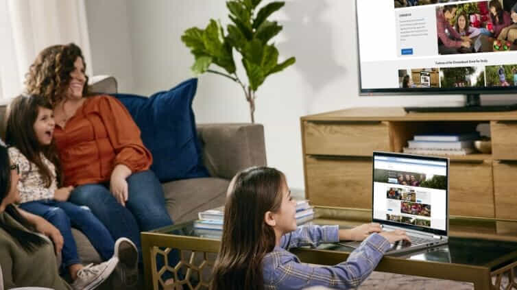 Girl using her Chromebook in family living room.  