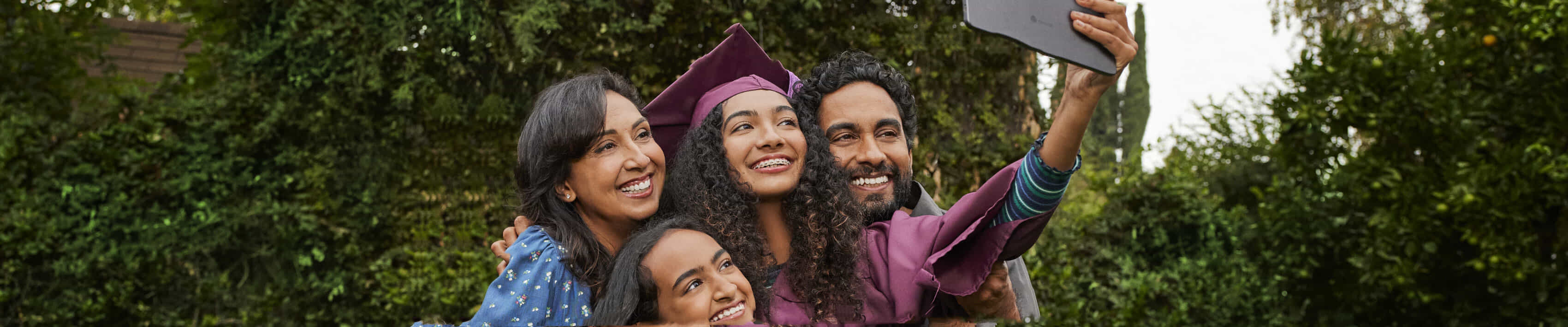 Family take a group selfie at Graduation with a Chromebook.  | The Good Guys
