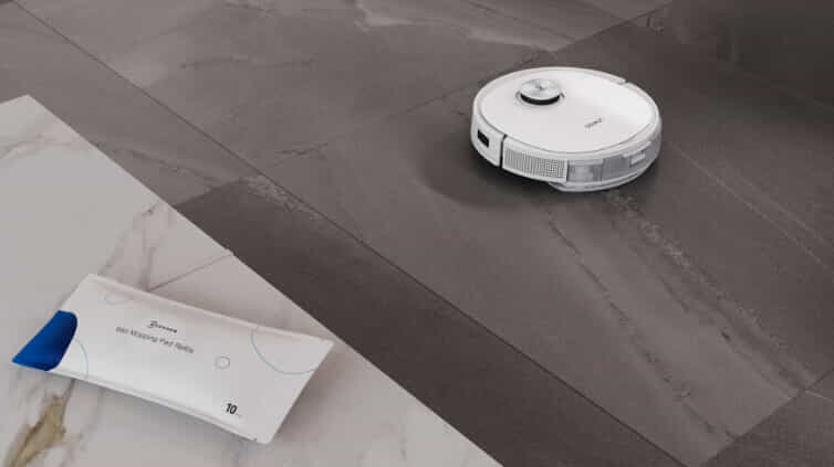 Showcasing that same robot vacuums vacuum and mop with a mopping pad positioned on a kitchen bench with the robot vacuum in the background.