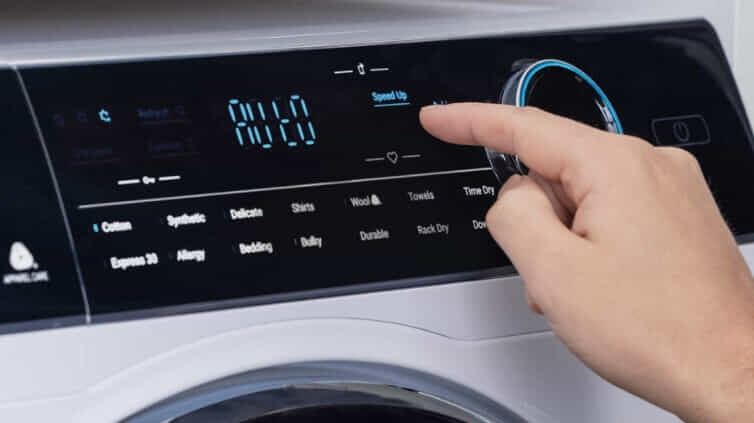 Person touching the control panels on a Haier dryer
