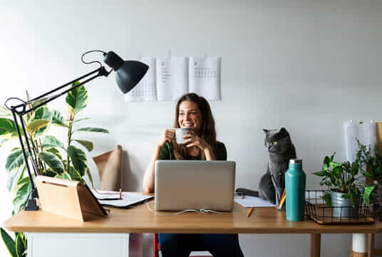 Woman sipping on coffee in her perfect home office