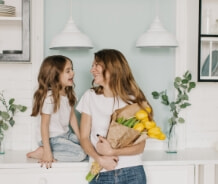 Woman and daughter in kitchen together