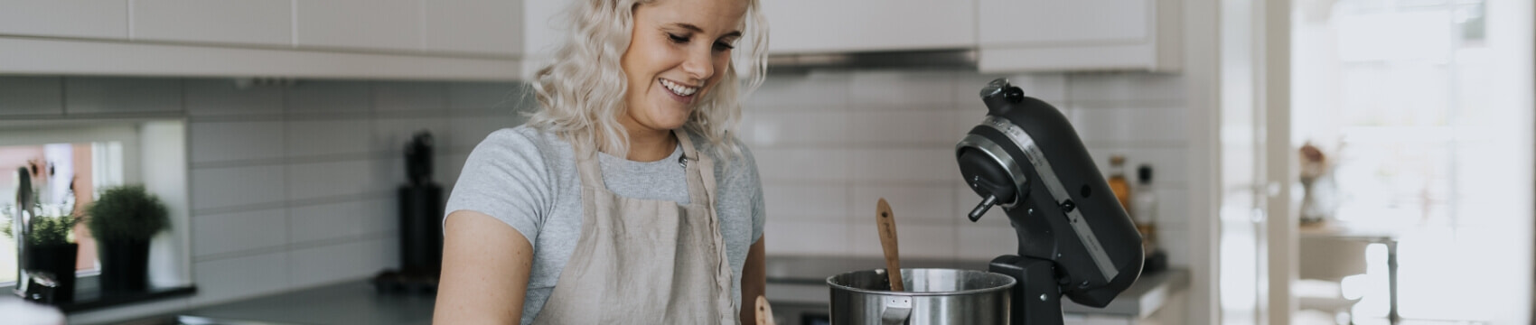 Woman using KitchenAid to do some baking.