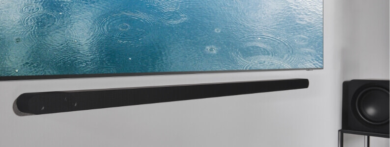 Close up of a Samsung soundbar that is wall mounted below Samsung TV